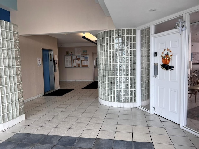 interior space with tile patterned floors and elevator