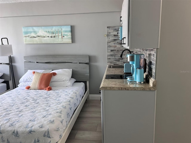 bedroom featuring dark hardwood / wood-style floors and sink