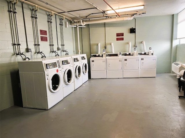 clothes washing area featuring separate washer and dryer