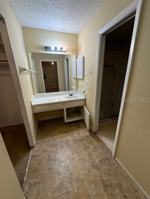 bathroom featuring vanity and a textured ceiling