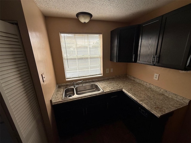 kitchen featuring sink and a textured ceiling