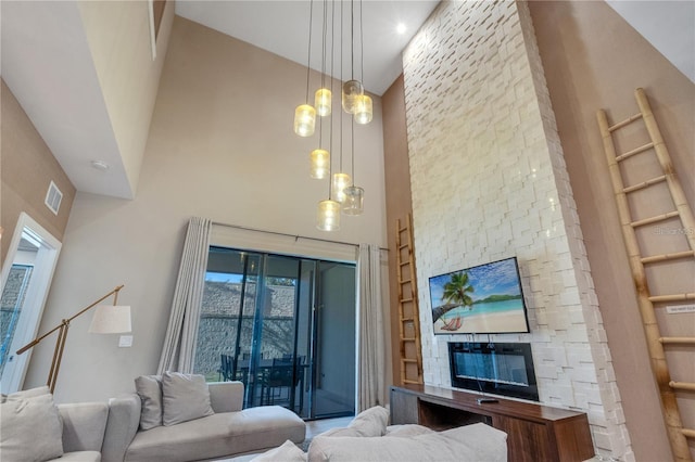 living room featuring a fireplace and a high ceiling