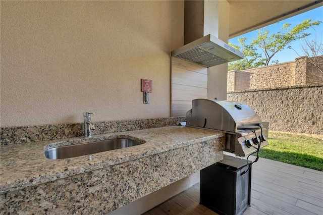 view of patio with sink and area for grilling