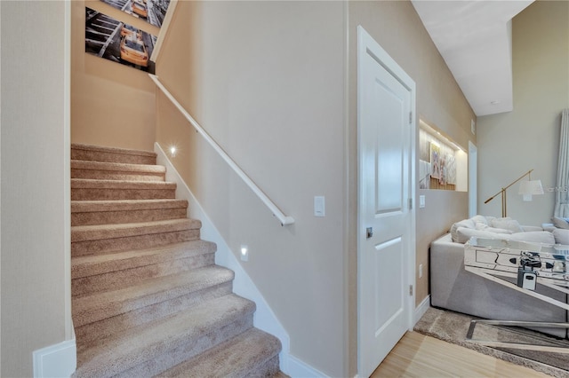 stairs with hardwood / wood-style flooring