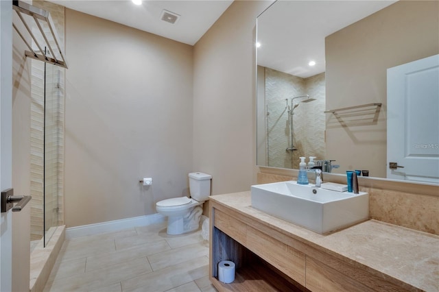 bathroom with toilet, an enclosed shower, vanity, and tile patterned floors