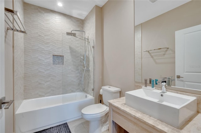 full bathroom with vanity, toilet, tiled shower / bath combo, and tile patterned flooring