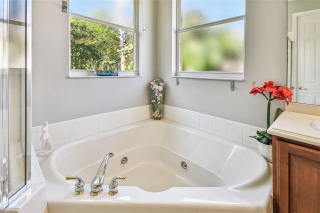 bathroom featuring vanity and a tub to relax in