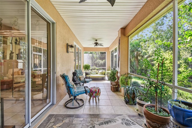 sunroom featuring ceiling fan