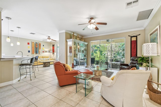 living room with ornamental molding and light tile patterned flooring