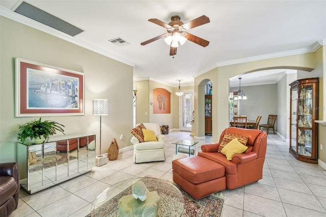 living room with ornamental molding, ceiling fan with notable chandelier, and light tile patterned floors