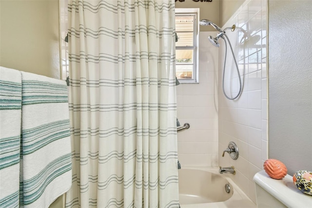 bathroom featuring toilet and shower / bath combo with shower curtain