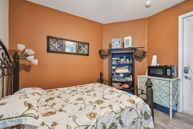 bedroom with hardwood / wood-style floors