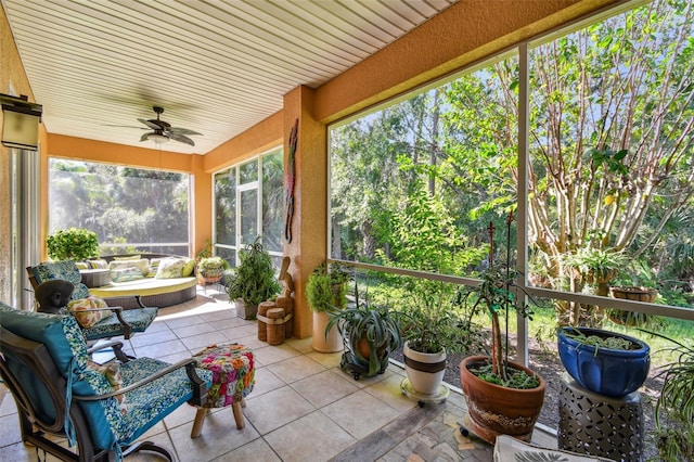 sunroom featuring ceiling fan