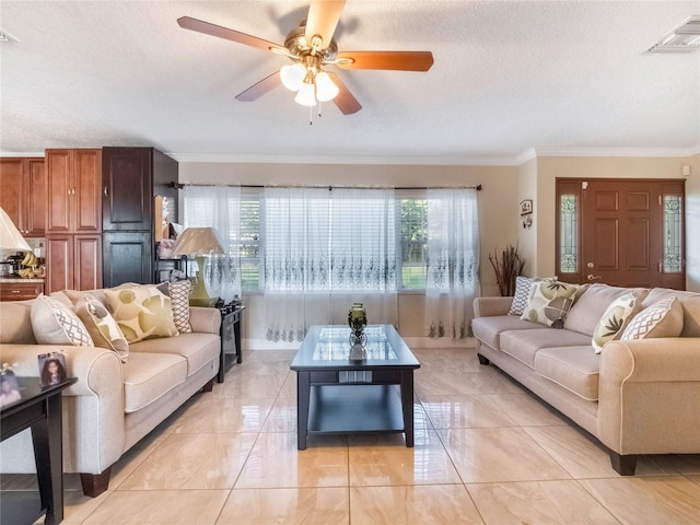 tiled living room featuring ornamental molding, ceiling fan, a textured ceiling, and plenty of natural light