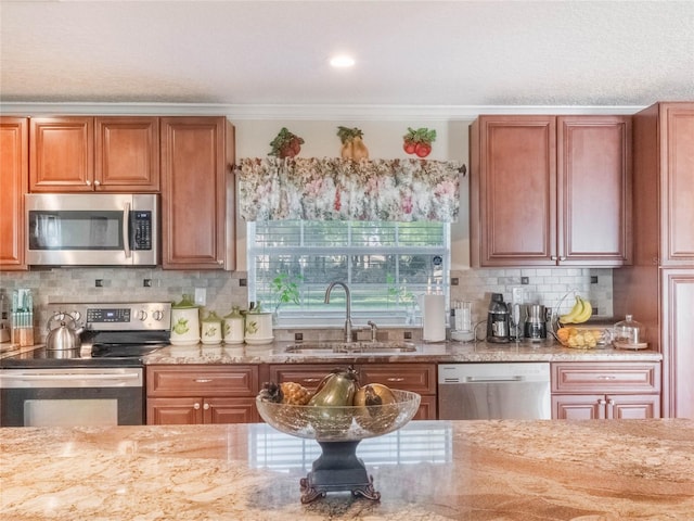 kitchen with stainless steel appliances, ornamental molding, sink, and tasteful backsplash