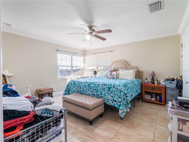 bedroom featuring tile patterned floors, crown molding, a textured ceiling, and ceiling fan