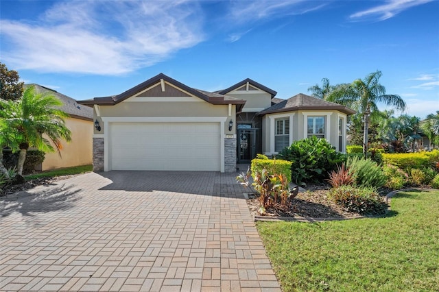 ranch-style home with a garage and a front lawn