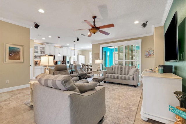 living room with ornamental molding and ceiling fan