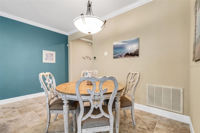 dining space featuring ornamental molding