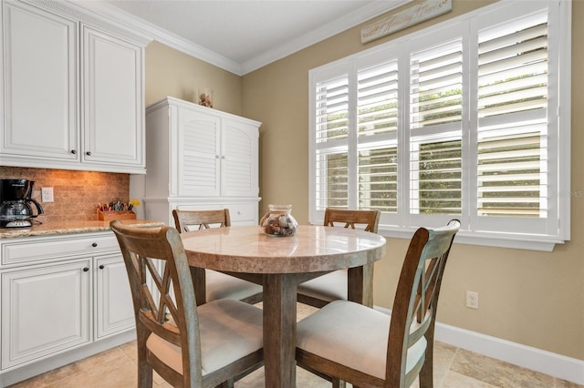 dining room featuring ornamental molding and light tile patterned floors