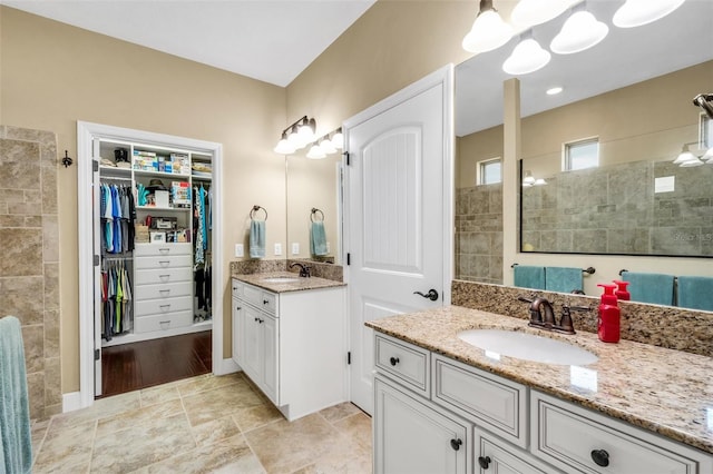 bathroom featuring vanity and tiled shower