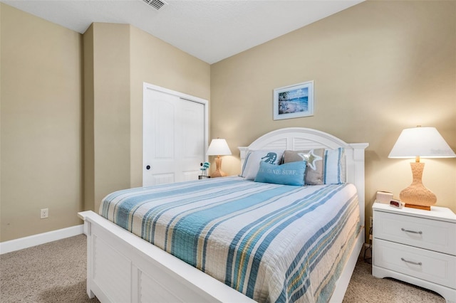 bedroom with a closet and light colored carpet