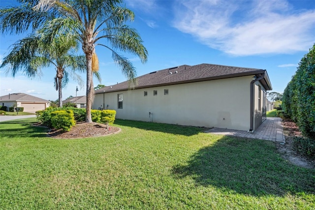 view of side of home with a lawn