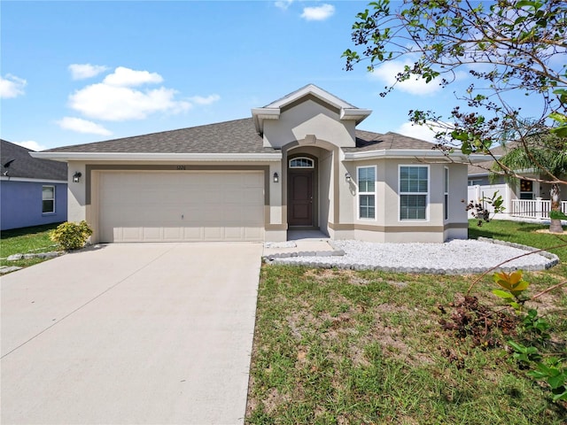 view of front facade with a front yard and a garage