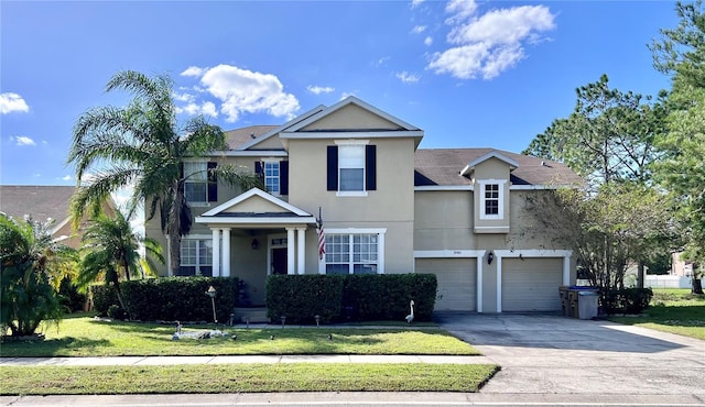 view of front of home featuring a front lawn and a garage