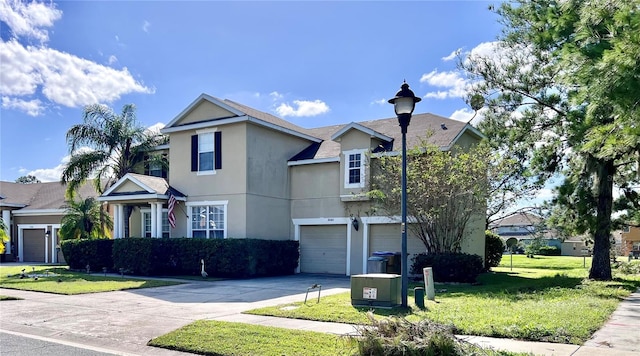 view of front property featuring a front lawn, central AC unit, and a garage