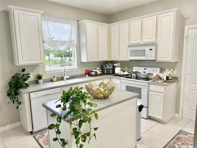 kitchen featuring white cabinets, sink, and white appliances