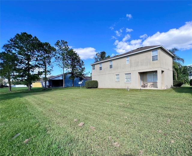 rear view of house with a lawn