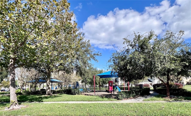 view of playground with a lawn