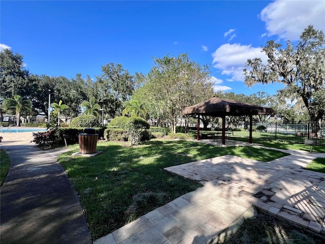 view of community with a gazebo, a lawn, and a swimming pool