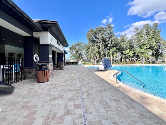 view of swimming pool with a patio