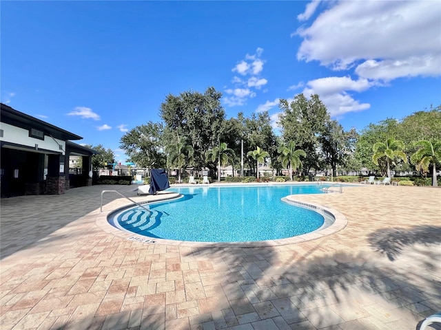 view of swimming pool featuring a patio area