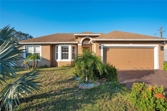 view of front of house with a front yard and a garage