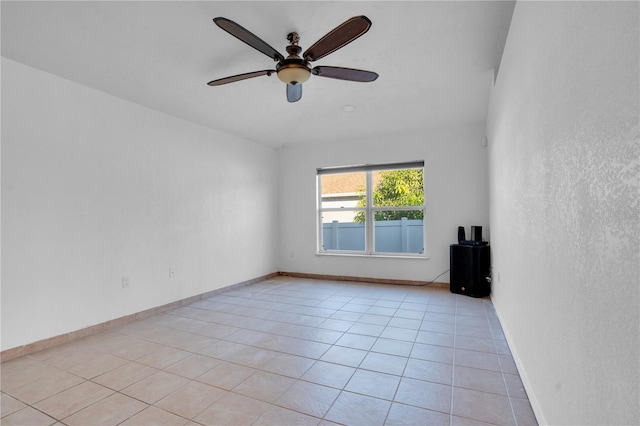 unfurnished room featuring ceiling fan and light tile patterned floors