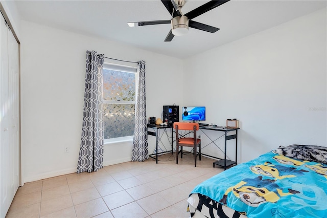 tiled bedroom featuring multiple windows, a closet, and ceiling fan