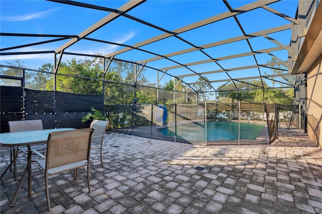 view of patio / terrace featuring a fenced in pool and glass enclosure