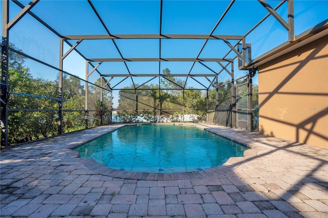 view of pool featuring a patio area and a lanai