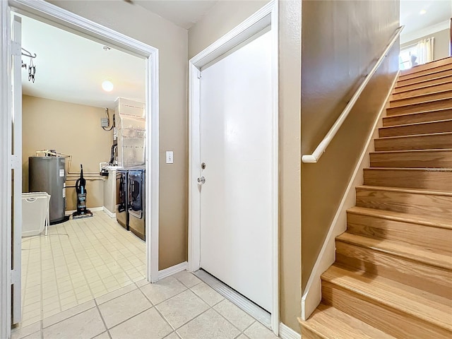 corridor with electric water heater and light tile patterned floors