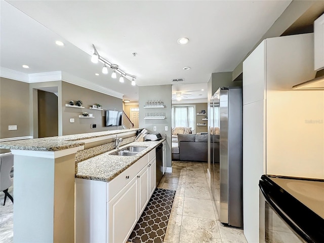 kitchen featuring sink, ornamental molding, light stone counters, white cabinetry, and stainless steel appliances