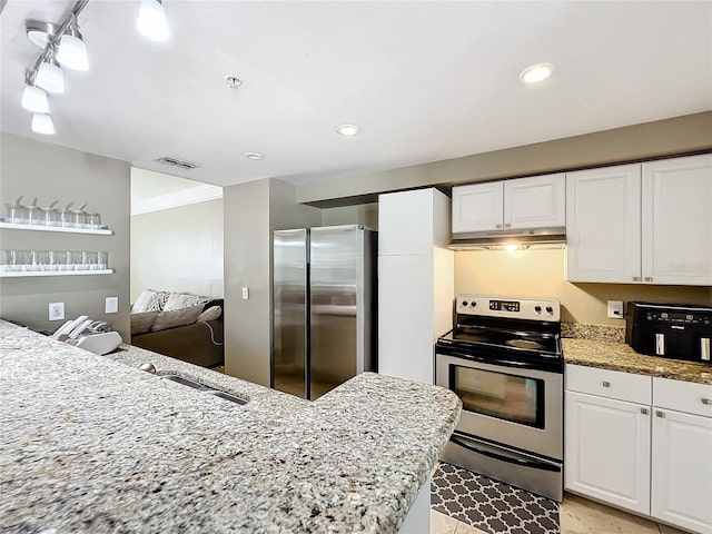 kitchen featuring white cabinets, stainless steel appliances, light stone counters, and crown molding