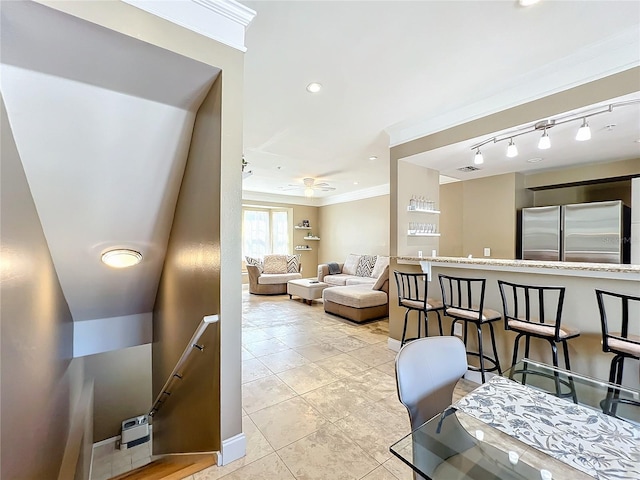 living room with light tile patterned floors and ornamental molding