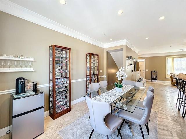 dining area featuring crown molding and light tile patterned floors