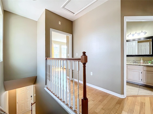 hall featuring light hardwood / wood-style flooring and sink