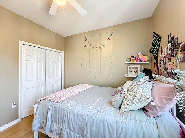 bedroom with ceiling fan, a closet, and light hardwood / wood-style flooring