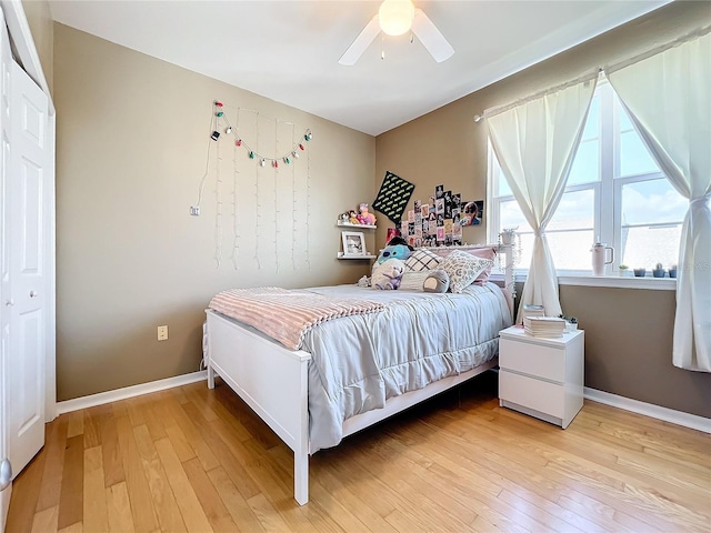 bedroom with a closet, ceiling fan, and hardwood / wood-style floors