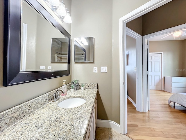 bathroom featuring ceiling fan, vanity, and hardwood / wood-style flooring